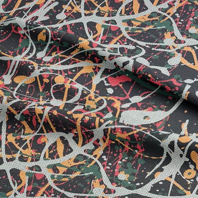 Close-up of black upholstery fabric with textured paint-style splashes in rust and ivory