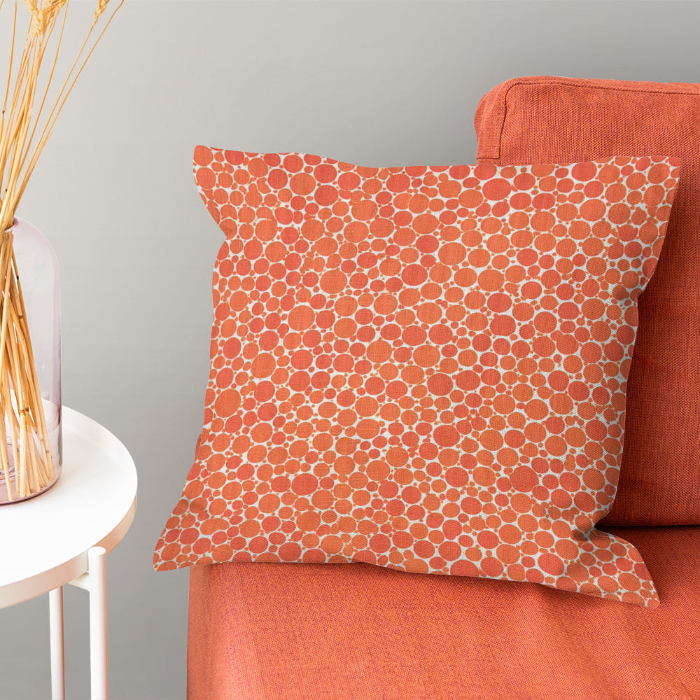 Cushion made in Pointillia No.1 orange polka dot curtain fabric for warm designer interiors