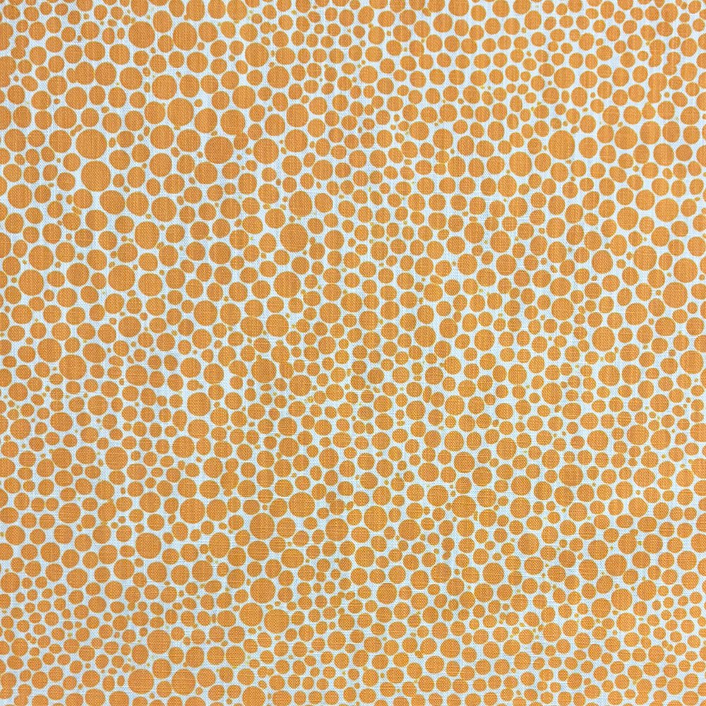Close-up of Pointillia No.5 printed upholstery fabric featuring a golden ochre dot pattern on a linen-blend weave.