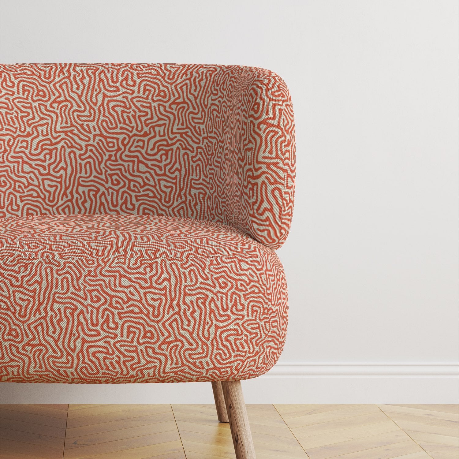 Armchair upholstered in Simplicity No.11 orange upholstery fabric with abstract line pattern