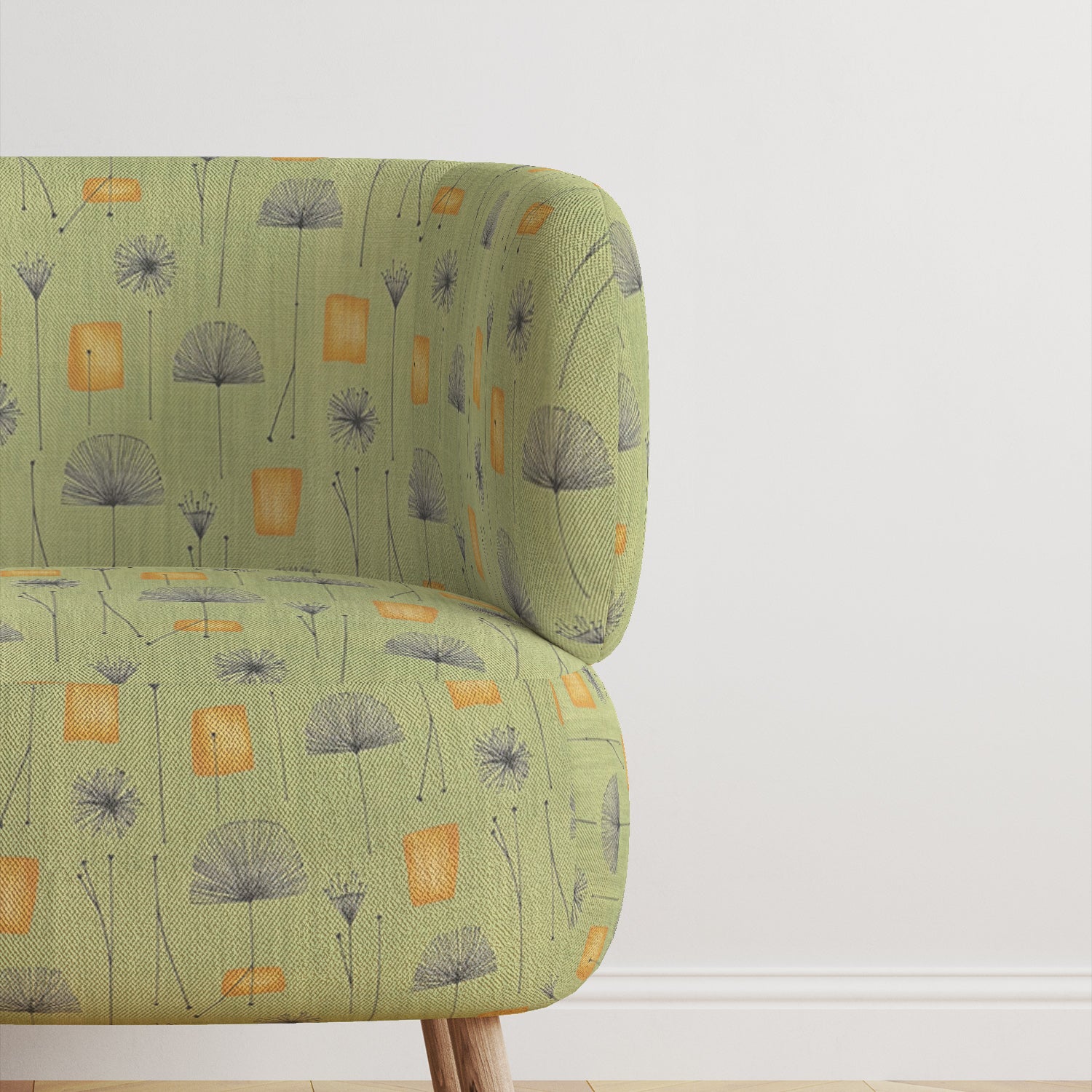 Modern armchair upholstered in green abstract dandelion-style fabric