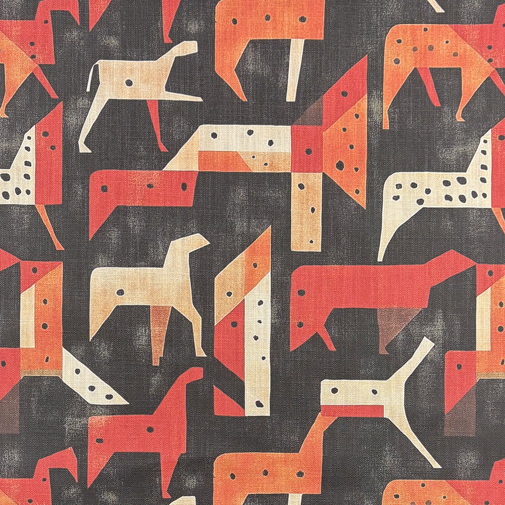 Orange tribal-inspired upholstery fabric with abstract animal figures – Tribute No.4 flat lay