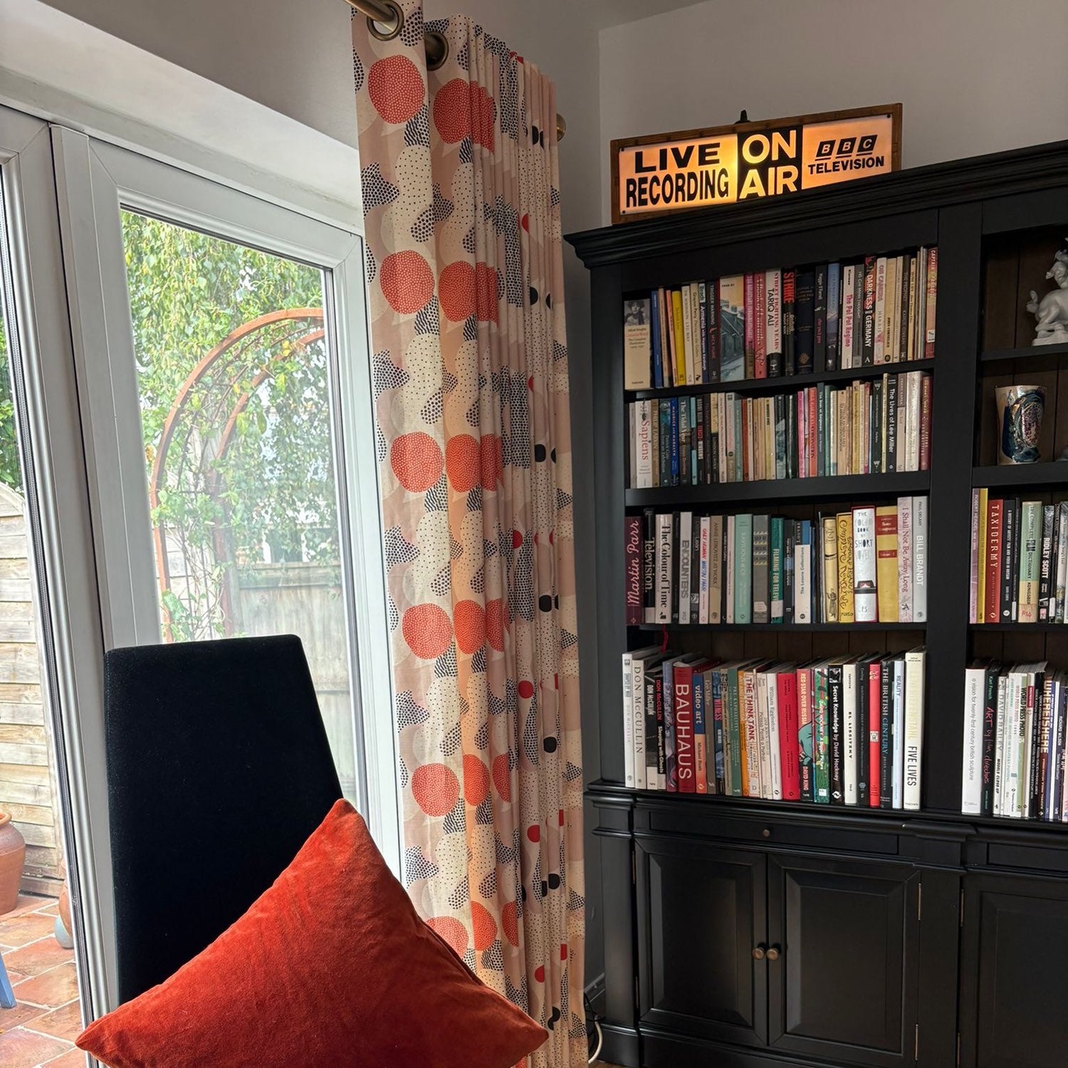 Abstract No.8 upholstery fabric made into curtains – bold retro-inspired design with red and black dot patterns in a modern living room setting