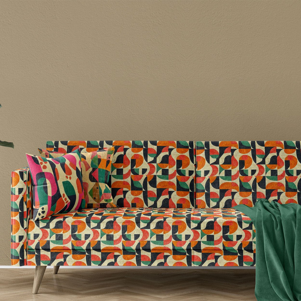 Sofa upholstered in Abstract No.22 green and orange mid-century geometric velvet