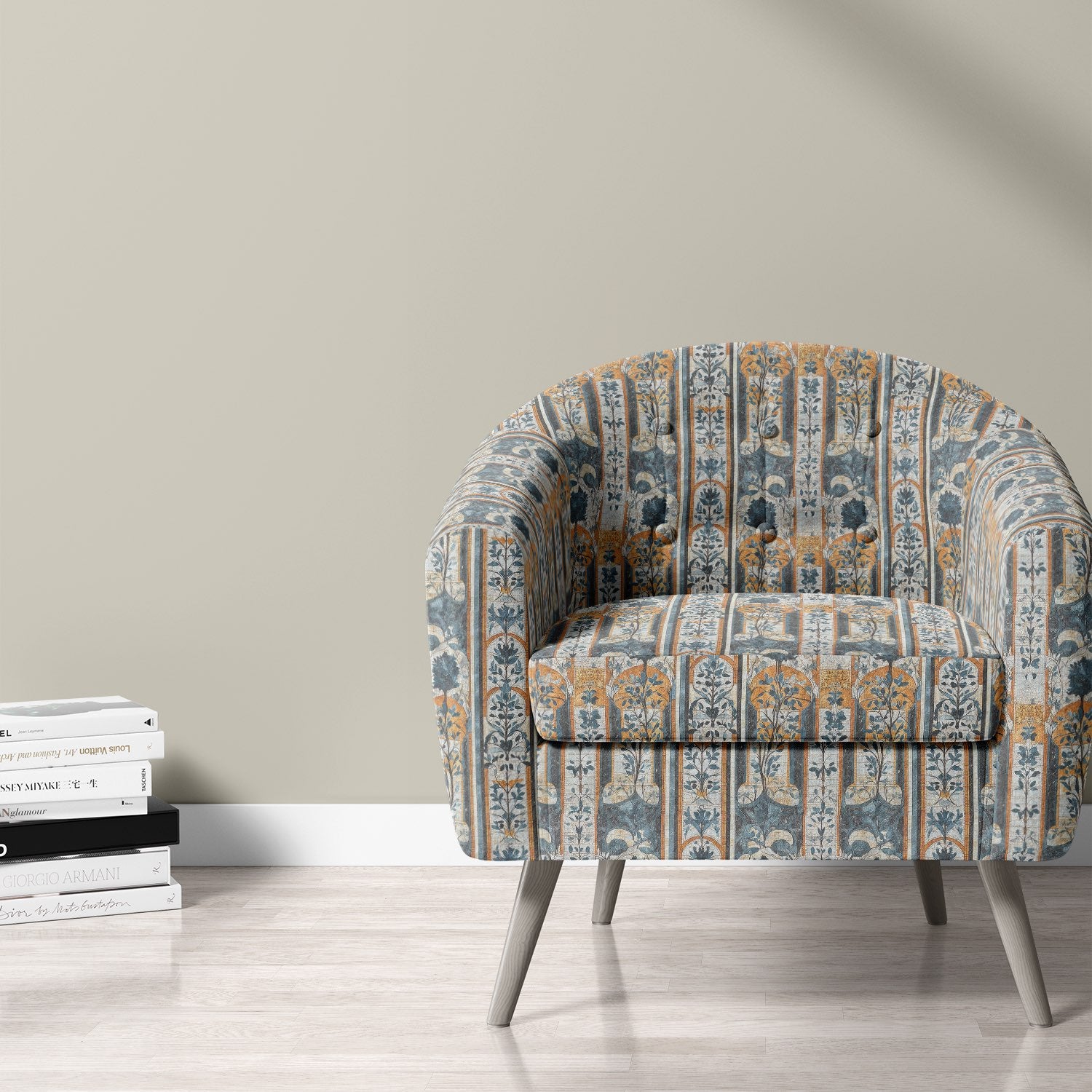 Agra No.3 blue and ochre upholstery fabric on an occasional chair with arched botanical print