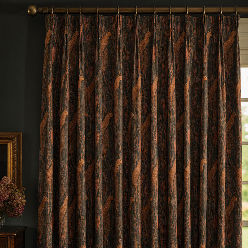 Animals No.10 linen curtain fabric shown as warm orange animal patterned curtains