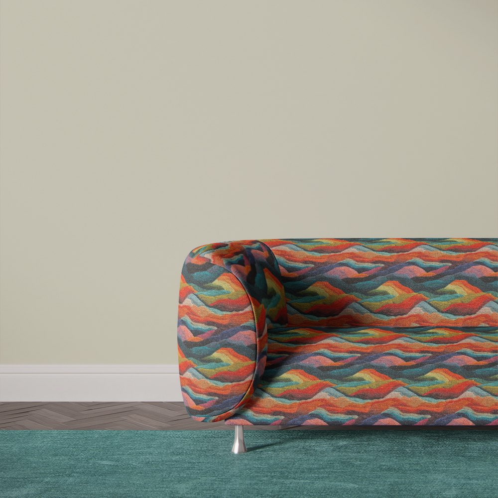 Multicoloured Arcadia No.10 upholstery fabric on a curved modern sofa in a bold, painterly abstract design