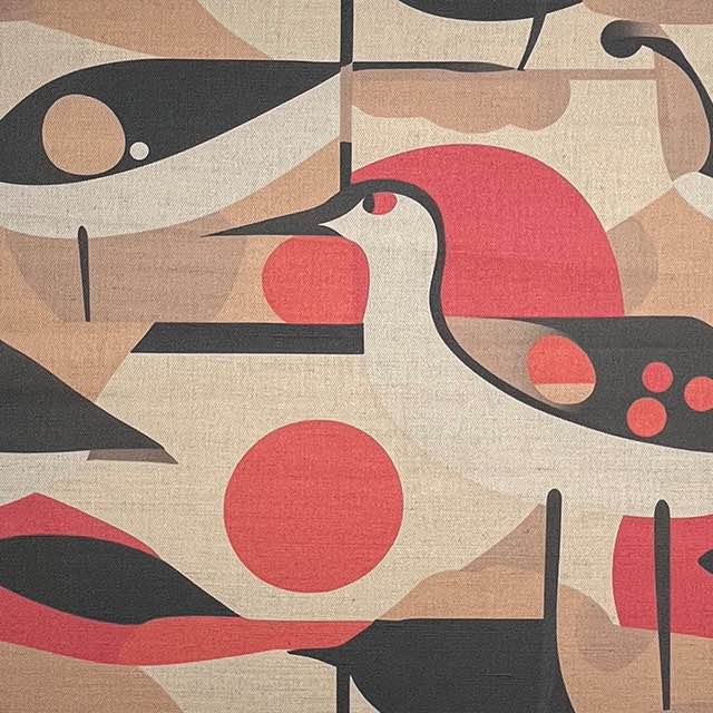 Abstract bird patterned upholstery fabric in soft clay, black, and coral on a cream base