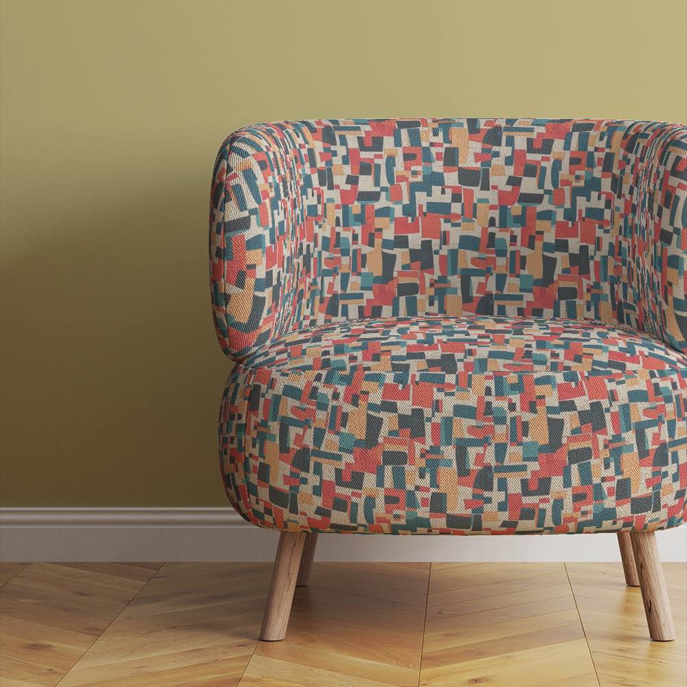 statement-armchair-upholstered-in-collage-no-8-fabric-showing-layered-rectilinear-forms-in-bold-earthy-tones