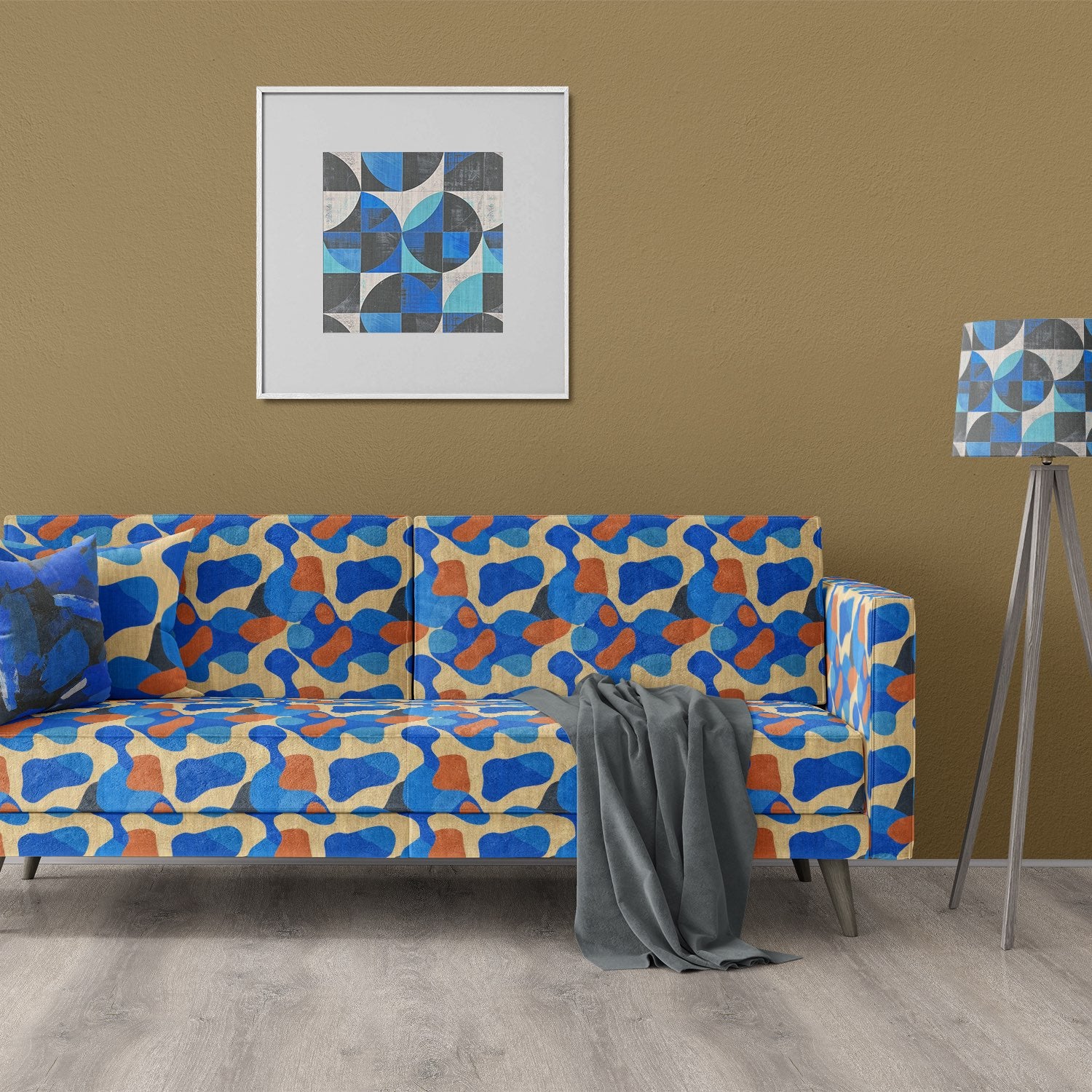 Modern sofa upholstered in Creation No.13 abstract upholstery fabric in blue and orange tones.