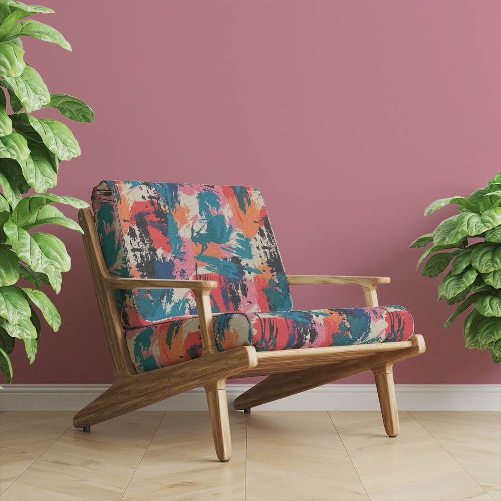 Statement armchair upholstered in Dash No.8 fabric, set in a blush-toned interior with plants