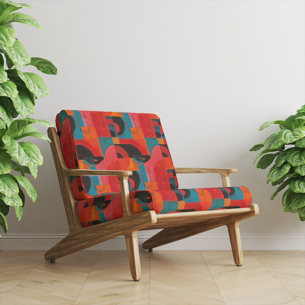 Mid-century armchair upholstered in Dessau No.7 abstract multicoloured upholstery fabric with curved black and red shapes