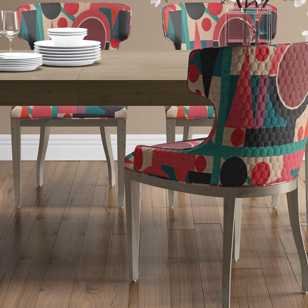 Modern dining chairs upholstered in Estaque No.5 fabric with bold abstract cubist shapes and rich colour palette