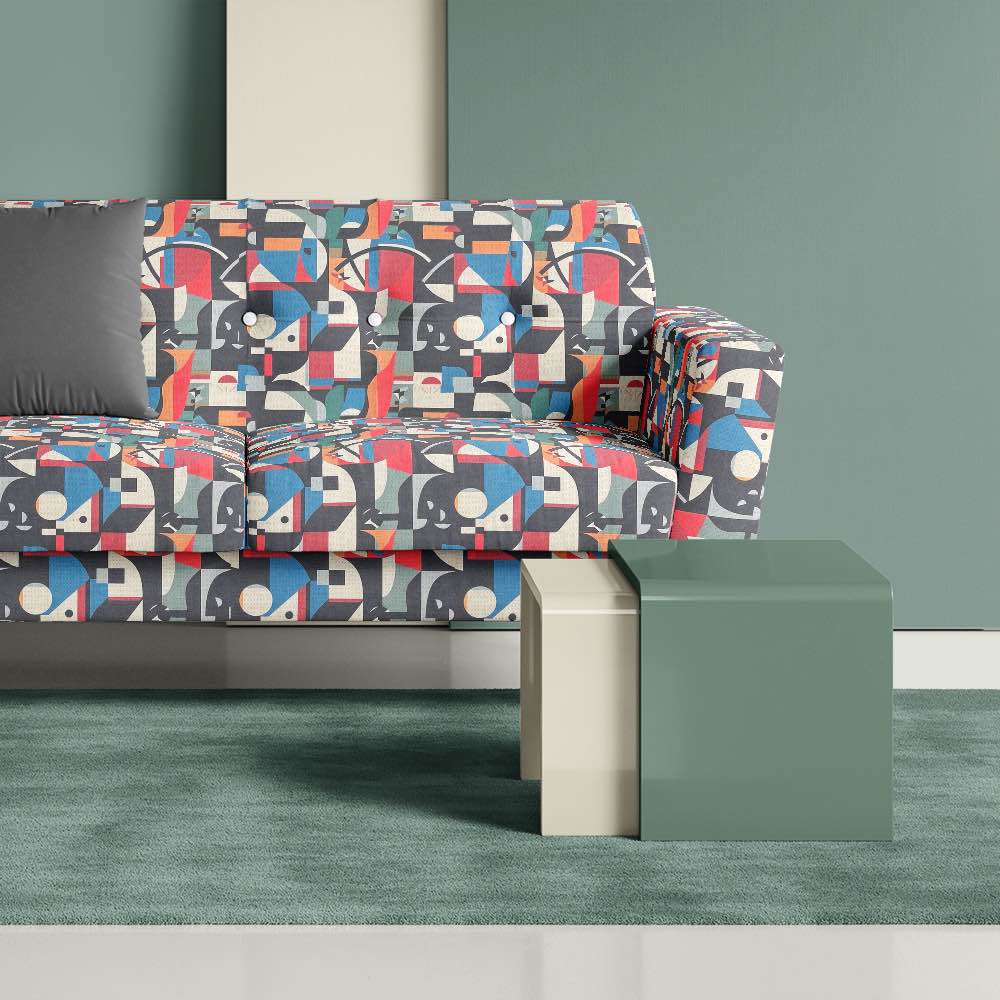 Contemporary accent sofa upholstered in Exhibite No.12 luxury fabric, placed on a soft green rug and sage painted backdrop