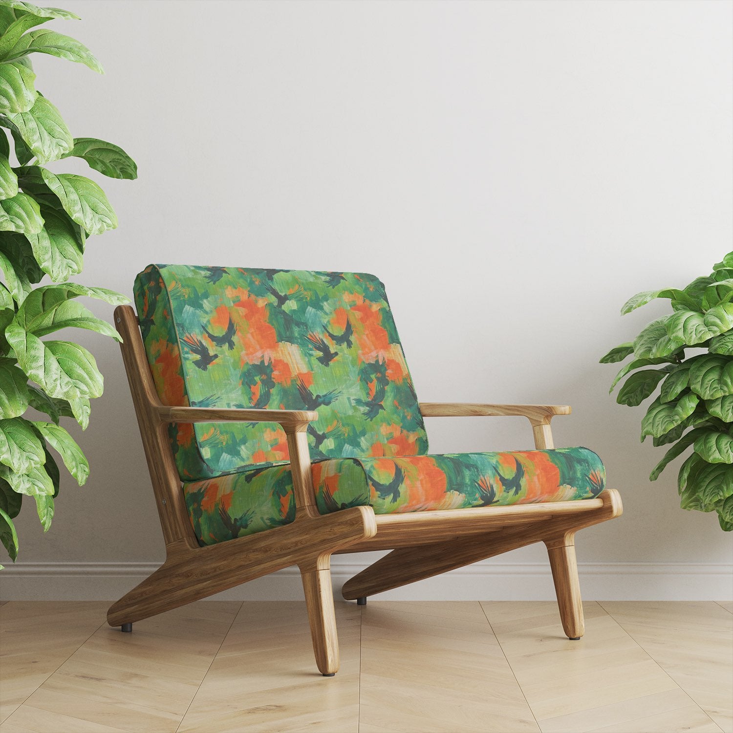 Mid-century armchair upholstered in Expressionism No.15 green and orange bird print upholstery fabric