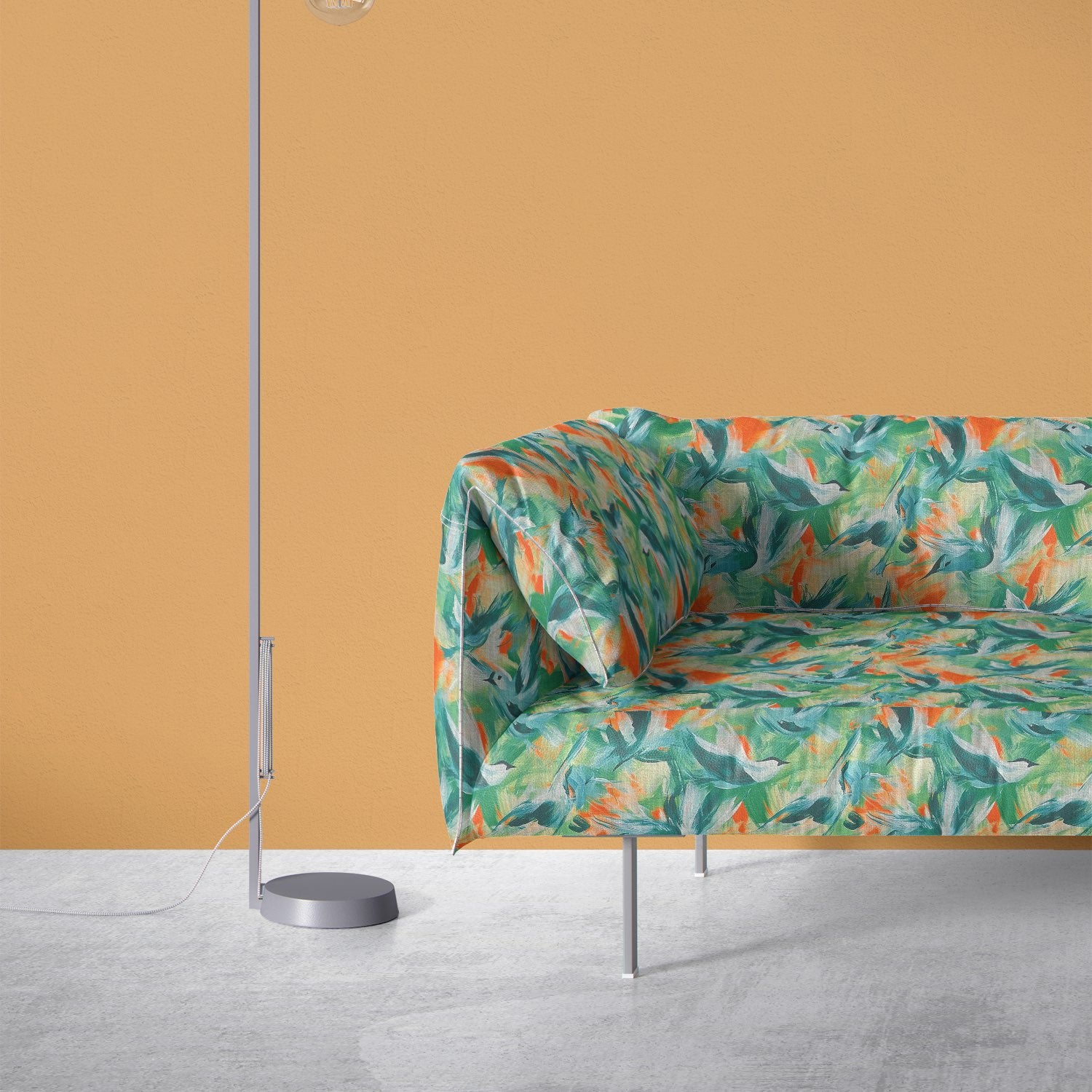Multicoloured bird design upholstery fabric on a modern sofa with teal, green, and orange brushstroke pattern