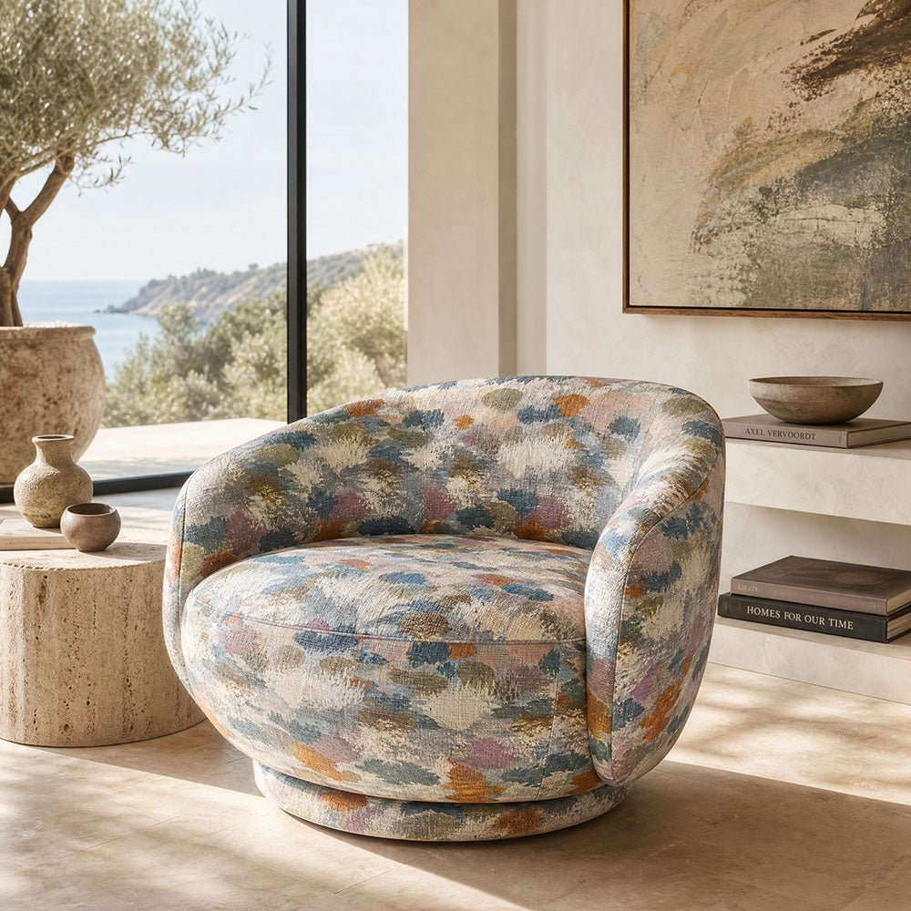 Fauve No.2 multicoloured abstract upholstery fabric on a rounded statement chair in a warm coastal interior