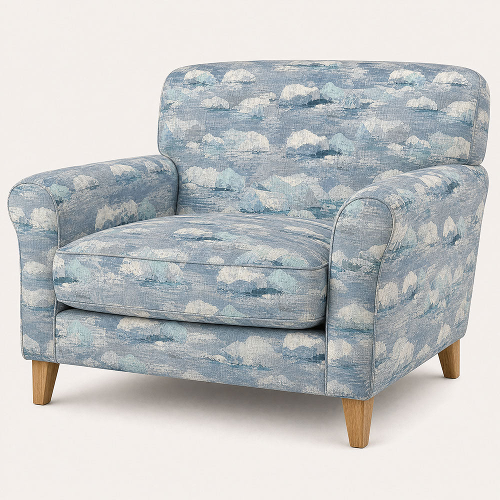 Fauve No.6 blue abstract upholstery fabric on a rounded statement chair in a light contemporary interior