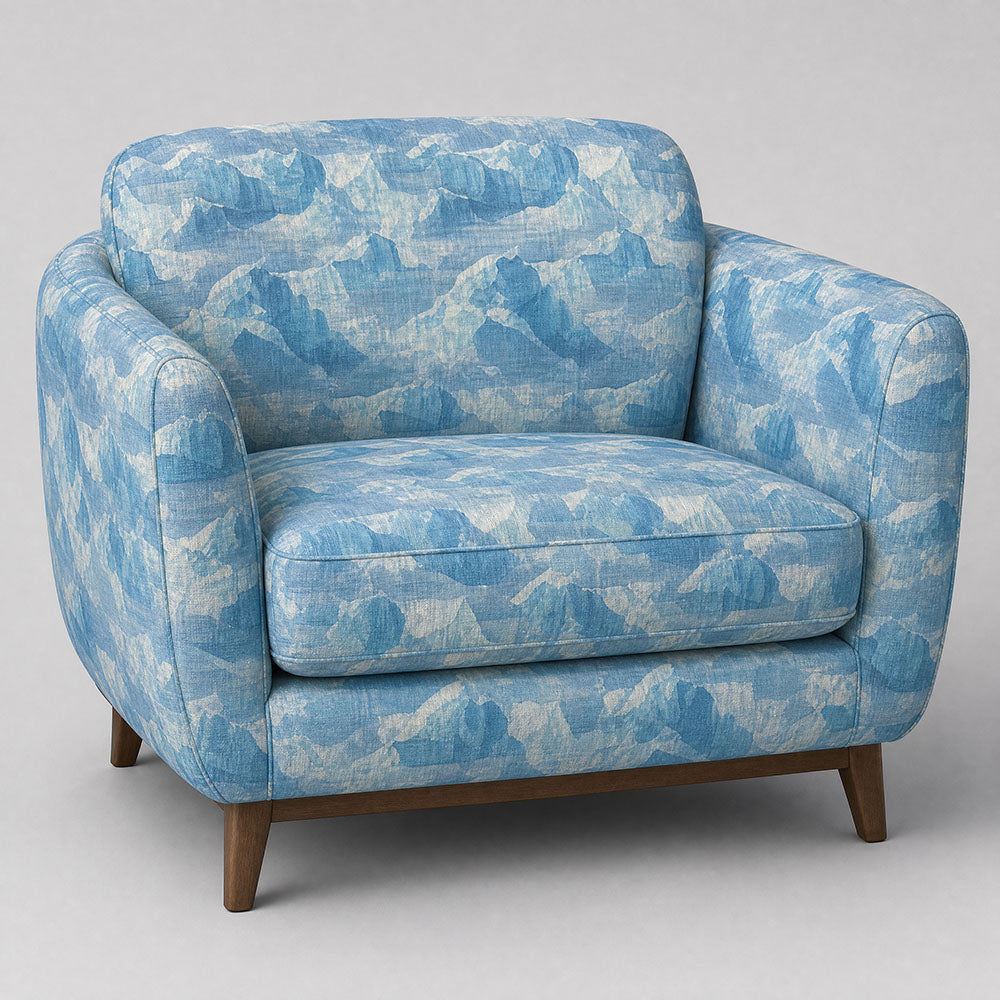 Fauve No.7 tonal blue abstract upholstery fabric on a rounded statement chair in a refined neutral room