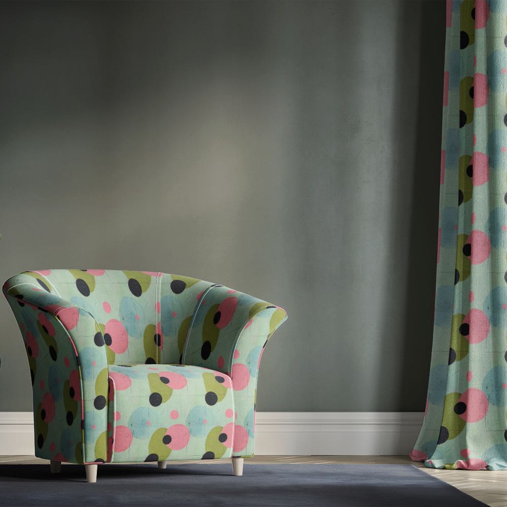 Duck egg upholstery fabric armchair with oversized abstract circle design in soft pastel tones within a modern interior