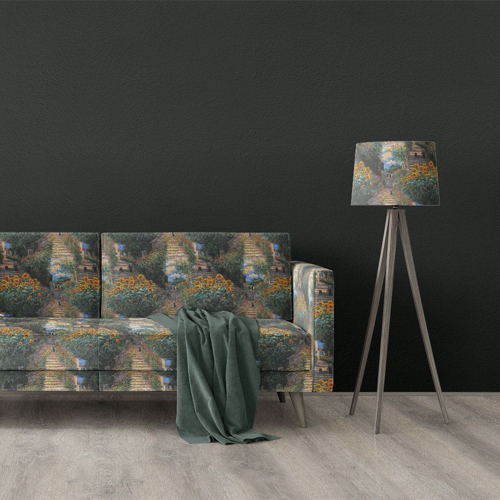 Giverny No.4 impressionist style upholstery fabric displayed on sofa and lampshade with floral garden pathway design in green, yellow and blue tones