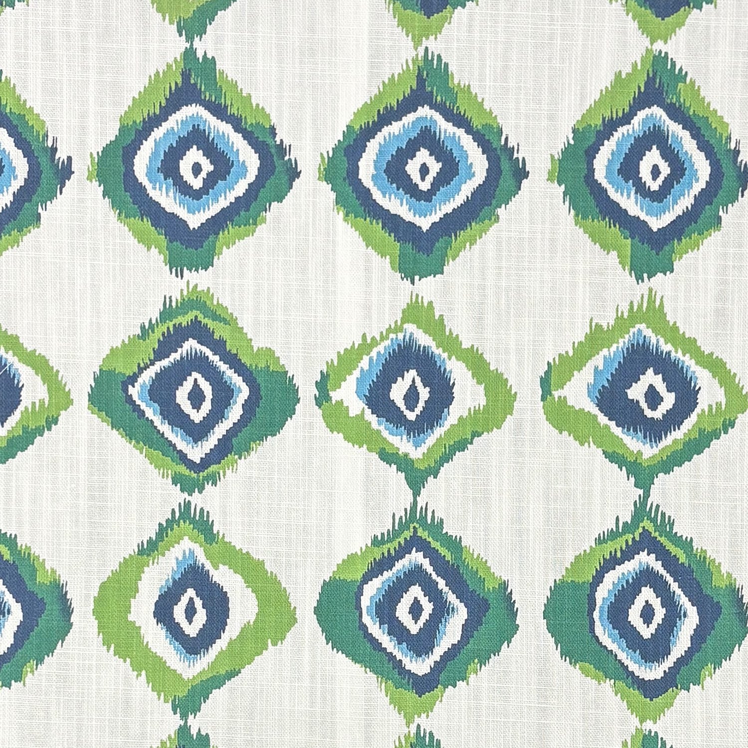 Flat image of Kilim No.23 upholstery fabric with repeated ikat-style diamond motifs in navy, green, and blue on an off-white base