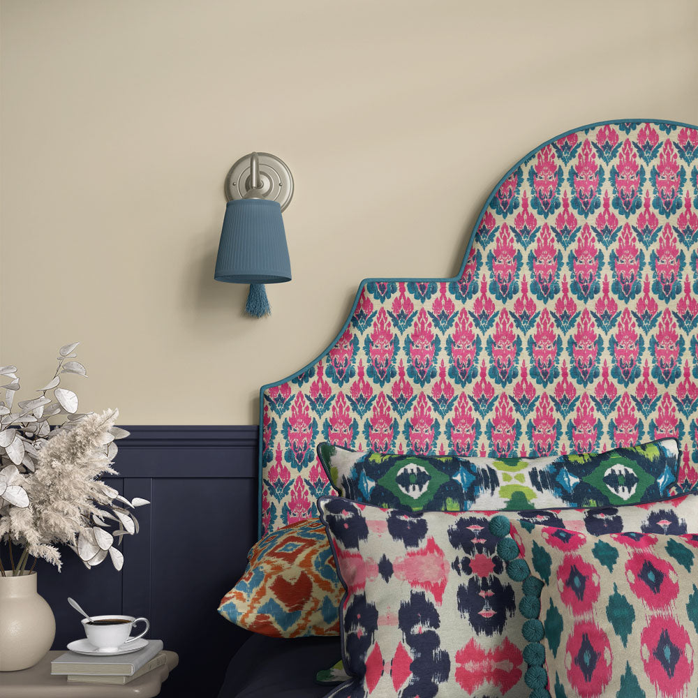 Headboard covered in Kilim No.33 Crib5 velvet upholstery fabric with pink and teal Kilim design