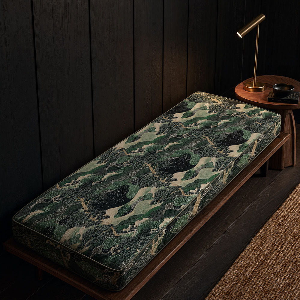 Scenic Japanese upholstery fabric featuring layered waves, woodland textures and landscape motifs in emerald green, sage and ivory tones upholstered onto a contemporary bench cushion