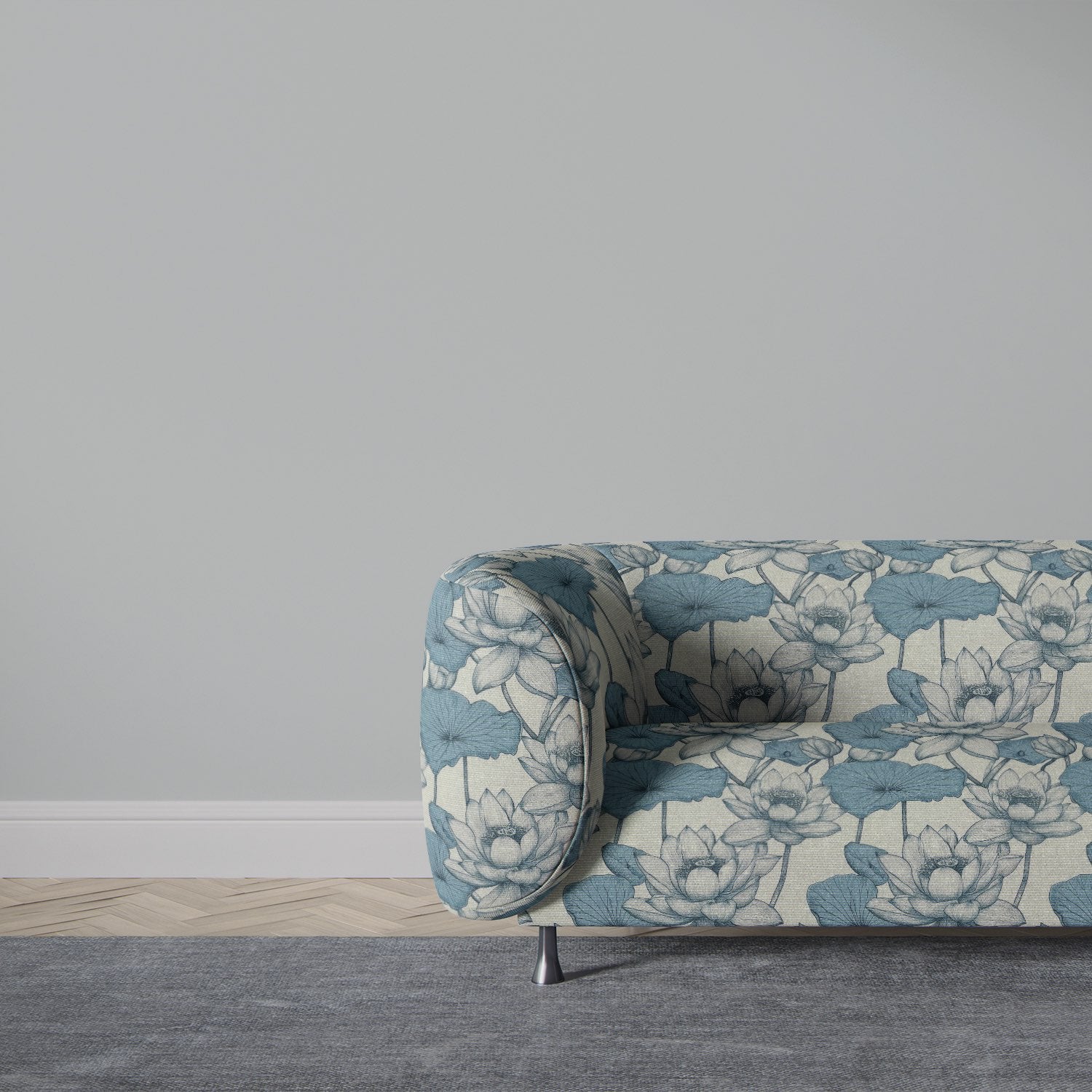 Armchair upholstered in Lotus No.9 blue floral upholstery fabric in modern living room setting