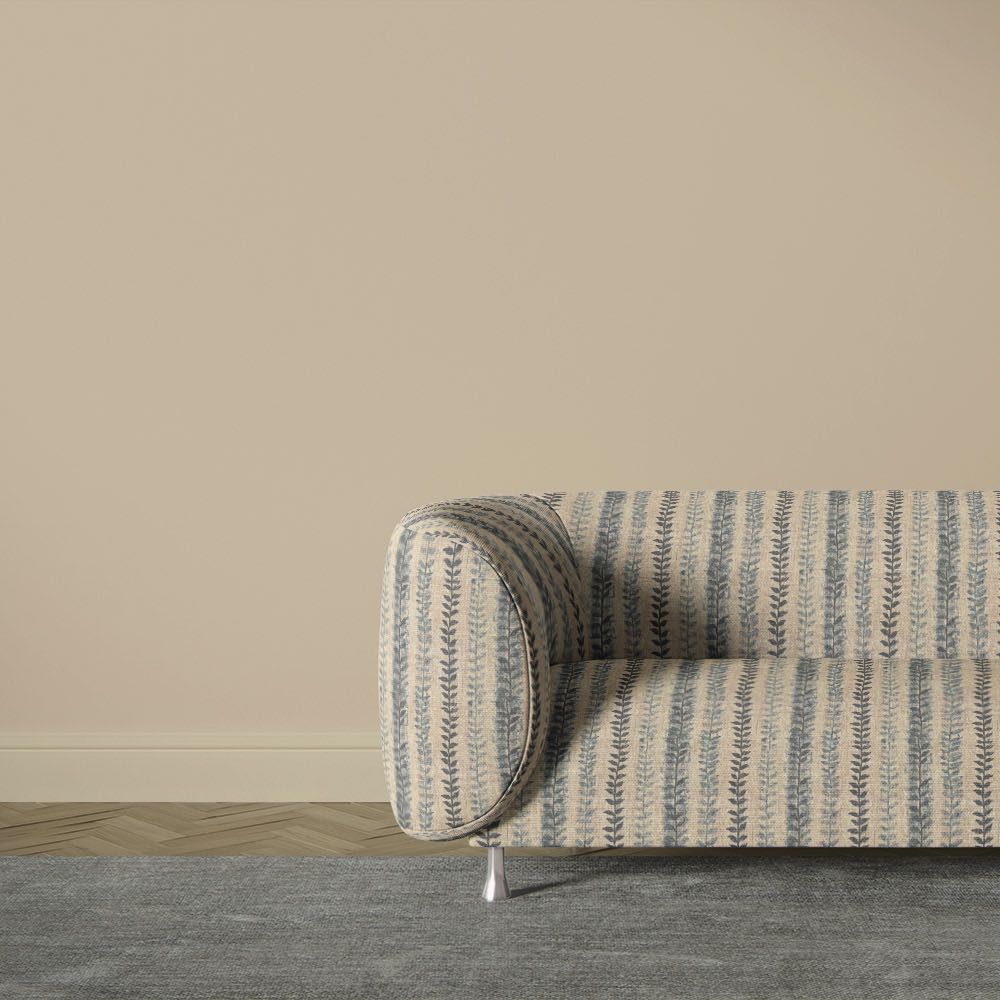 Lovverk Stripe No.10 blue Scandinavian leaf stripe upholstery fabric on a curved sofa