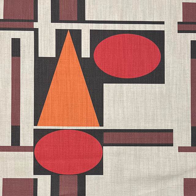 Bauhaus-inspired upholstery fabric with terracotta circles and triangle – Malaga No.12 flat lay