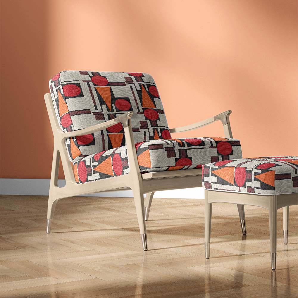 Malaga No.13 fabric styled on accent chairs in Bauhaus red, ivory and black