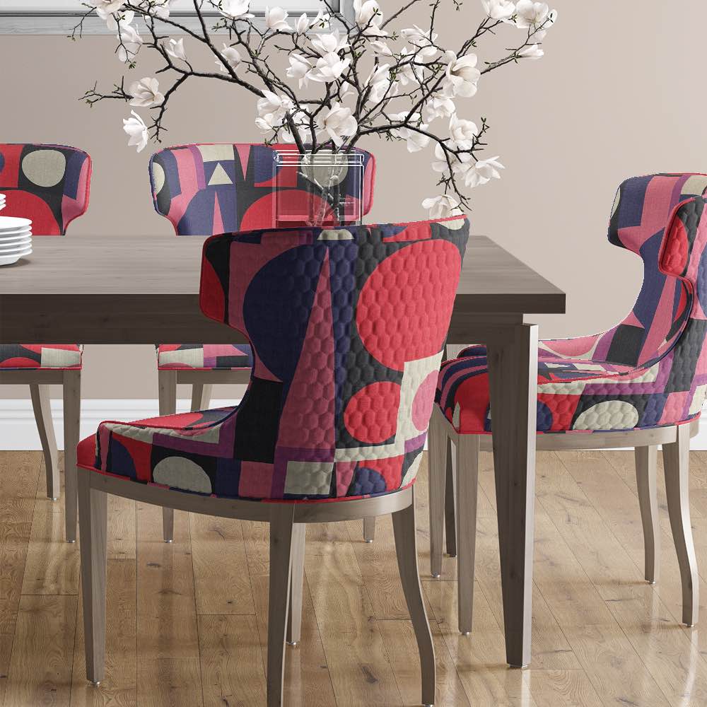 Malaga No.19 styled on dining chairs with pink, blush, and navy cubist print