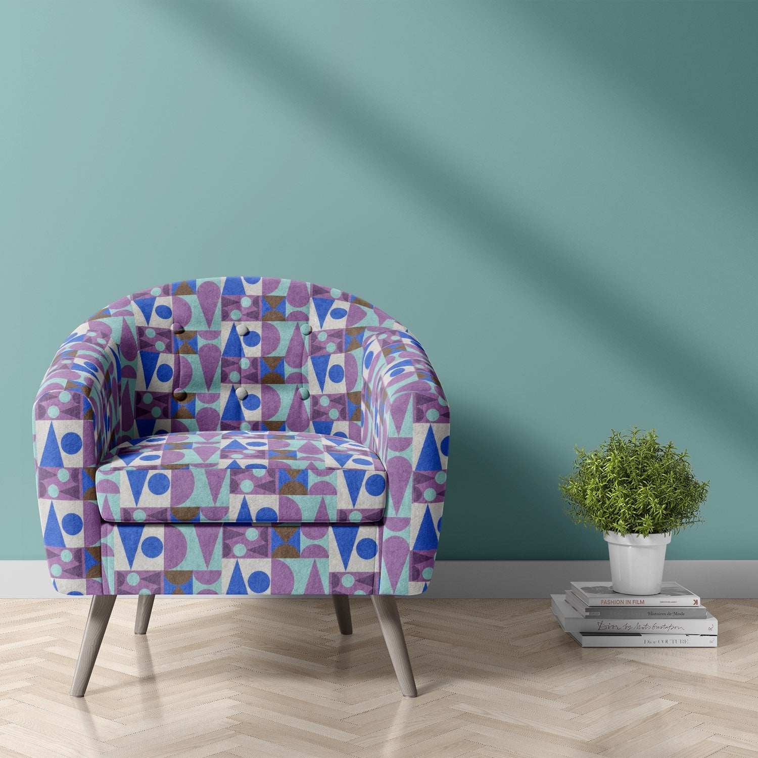 Armchair upholstered in Malaga No.25 geometric cubist upholstery fabric with bold purple and blue design.