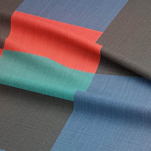 Close-up of colourful upholstery fabric with abstract blocks and textured weave
