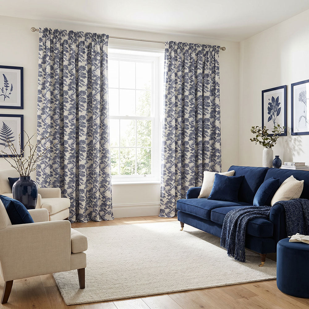 Japanese curtain fabric featuring intricate woodland scenes, pine trees and botanical motifs in navy blue and ivory tones styled as elegant full-length curtains