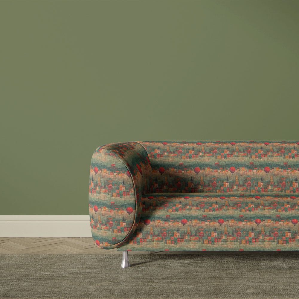 Artistic abstract upholstery fabric sofa featuring geometric village scene with muted green and terracotta colour palette