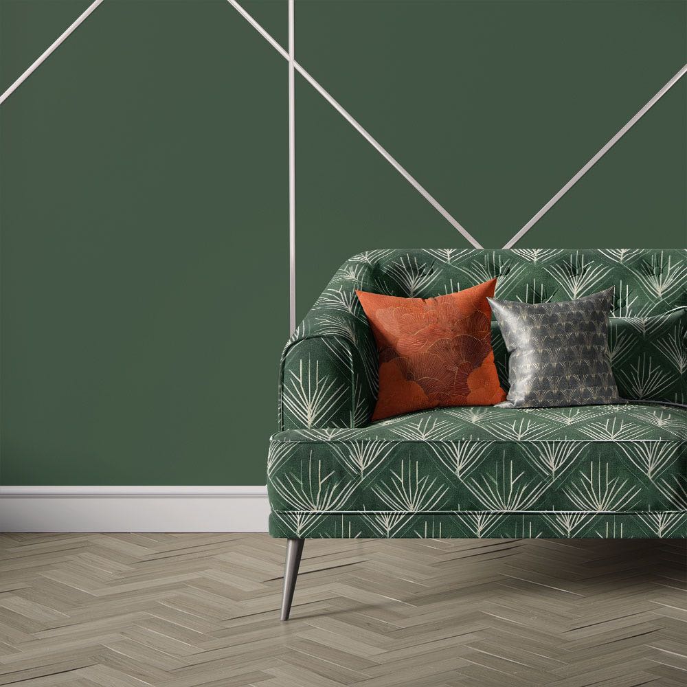 Nouveau Velvet No.10 printed velvet fabric upholstered on sofa featuring emerald green Art Deco fan pattern with ivory decorative detailing