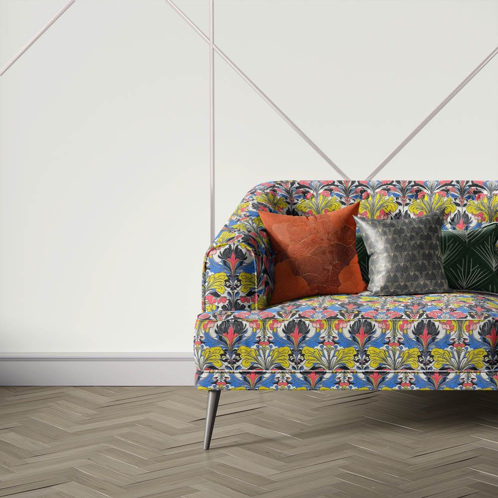 Nouveau Velvet No.3 printed velvet fabric upholstered on contemporary sofa showcasing colourful Art Nouveau floral pattern in blue, yellow and coral tones
