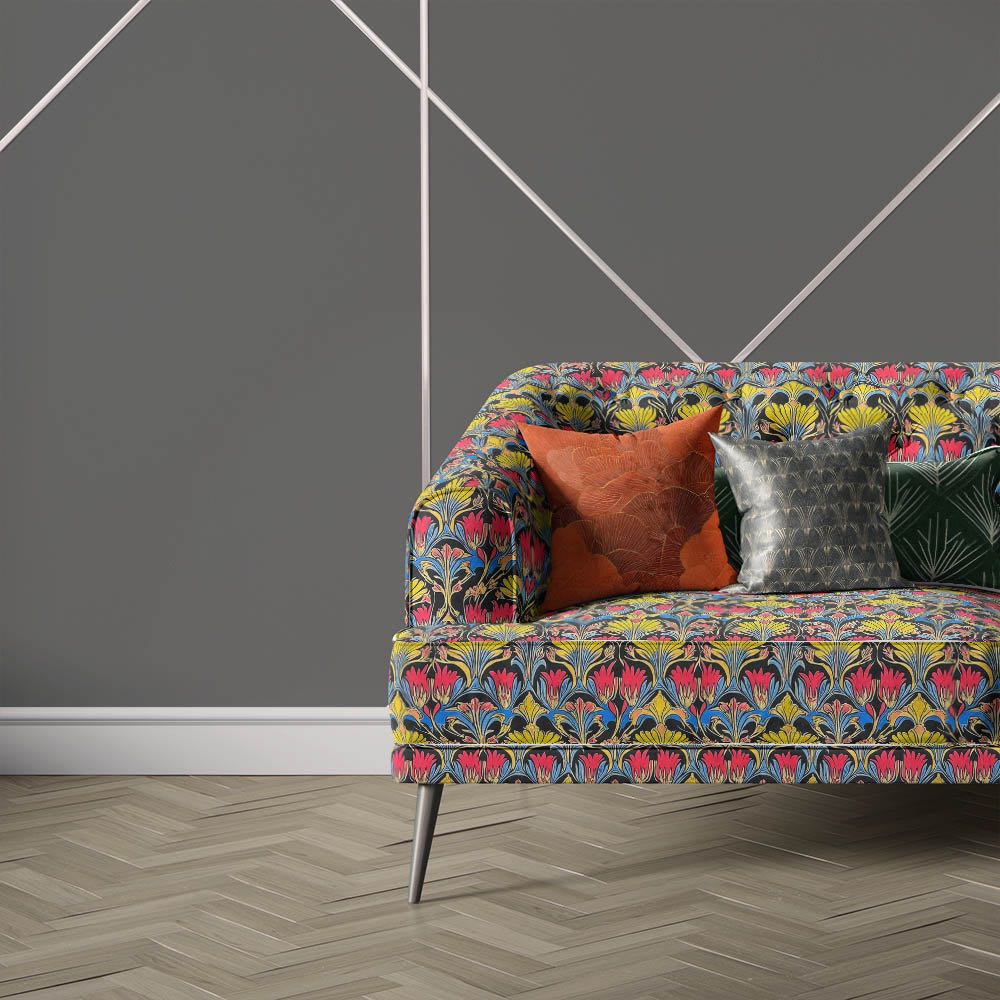 Nouveau Velvet No.4 printed velvet fabric upholstered on contemporary sofa showcasing colourful Art Nouveau floral design in pink, yellow and blue tones