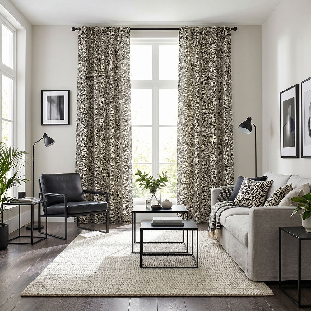 Abstract curtain fabric featuring intricate hand-drawn linework and organic maze-inspired patterns in neutral taupe and charcoal tones styled within a contemporary living room