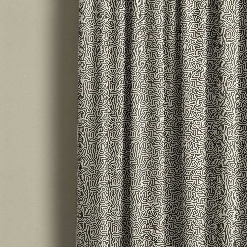 Modern black and cream abstract printed linen curtain fabric with flowing organic line pattern in contemporary interior setting