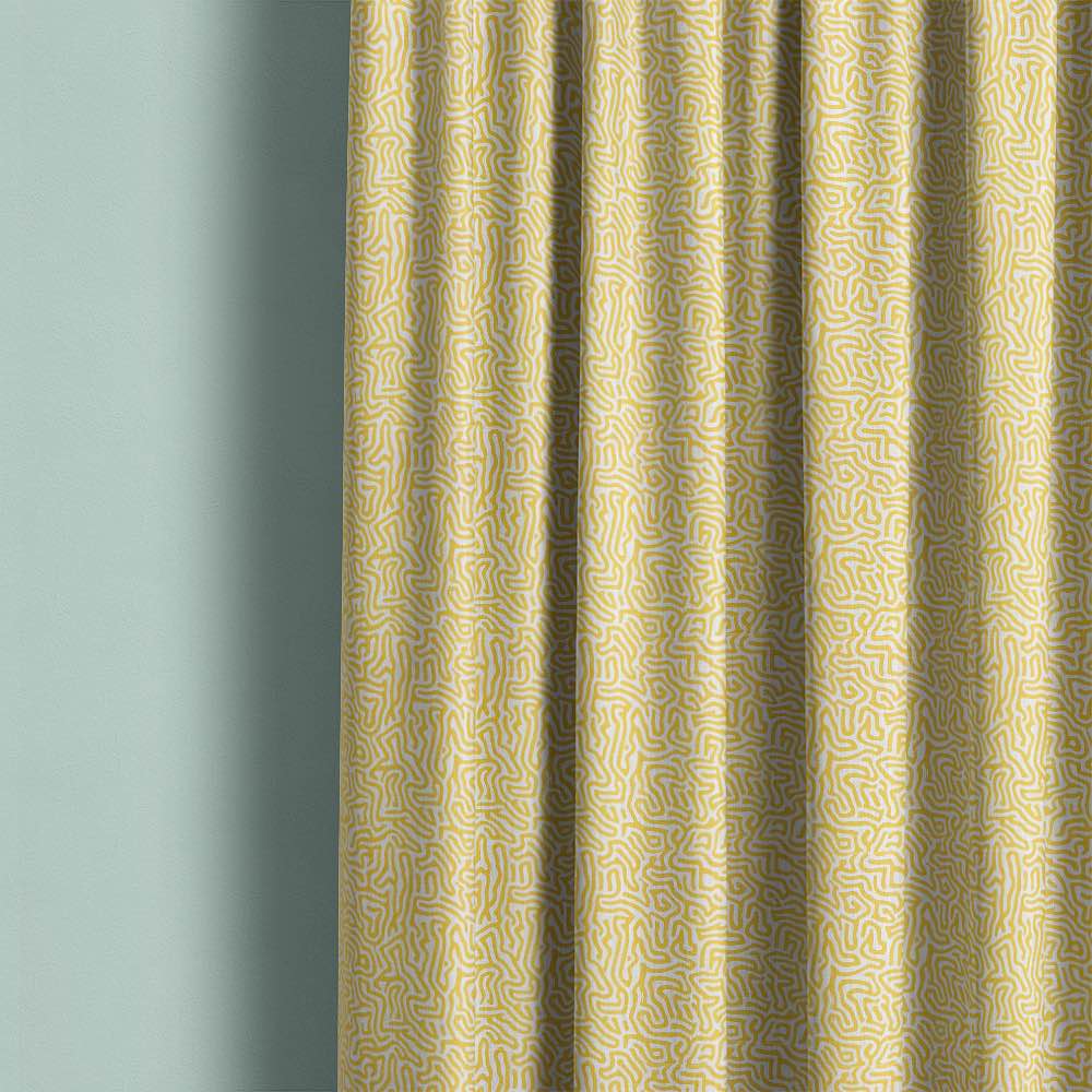 Contemporary yellow linen curtain fabric featuring organic abstract printed linework in modern interior setting