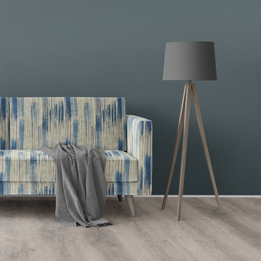 Blue and neutral striped upholstery fabric on modern sofa in interior setting – Striped No.21 by Saint and Poet