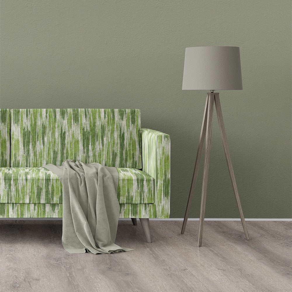 Sofa upholstered in Striped No.29 green striped upholstery fabric shown in a styled modern interior setting