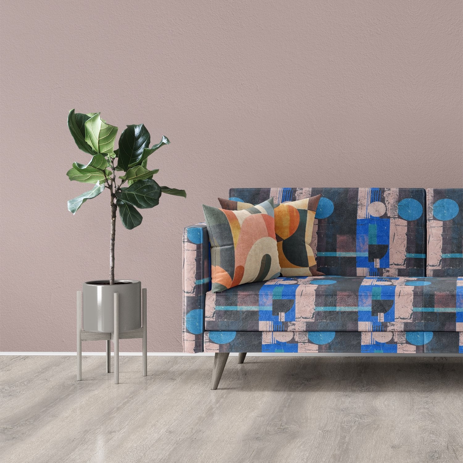 Sofa upholstered in Symbolic No.20 abstract geometric upholstery fabric with bold blue and pink shapes