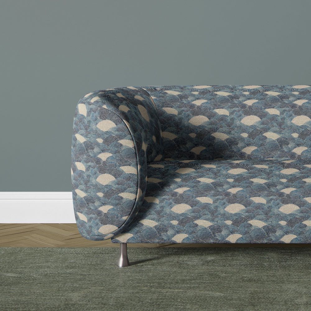 Texture No.10 blue upholstery fabric on sofa featuring flowing wave motif with layered blue tones and soft neutral background