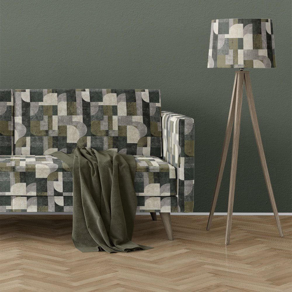 Texture No.12 green upholstery fabric on sofa featuring mid century geometric design with curved shapes and layered green and neutral tones