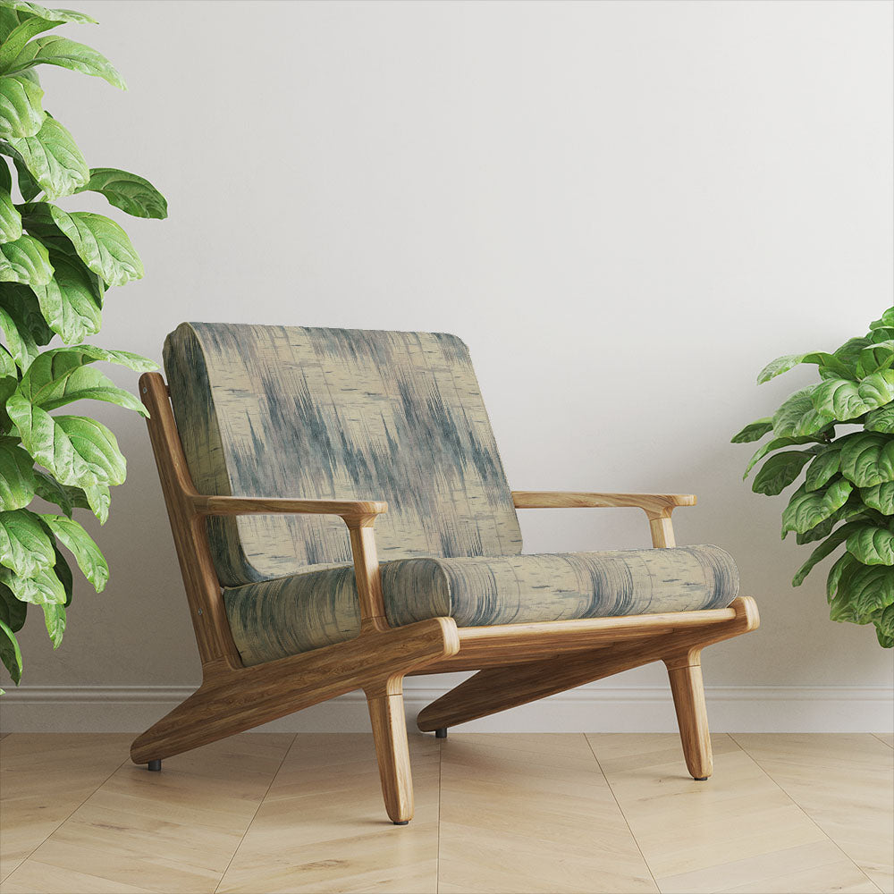 blue upholstery fabric on armchair featuring a printed textured design with soft vertical brushstroke pattern and neutral base