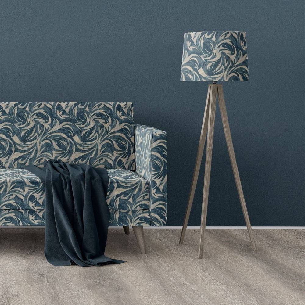 Texture No.6 blue upholstery fabric on sofa showing swirling painterly design in deep blue tones with soft textured printed finish